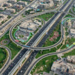 Aerial view of JVC Dubai showing metro access, bus stops, and major highways for commuter routes.