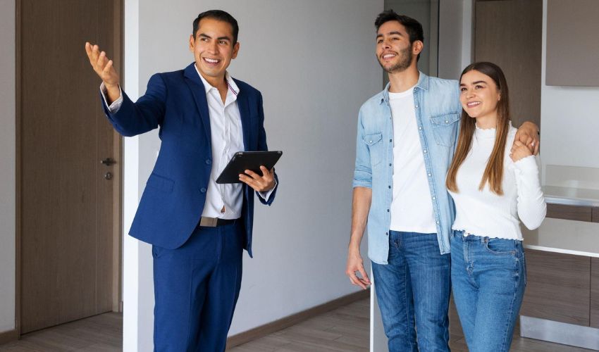 Real estate agent presenting property options to expat couple.