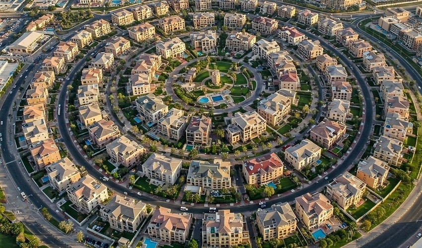 Aerial view of JVC Dubai showing green spaces, residential towers, and proximity to major landmarks.