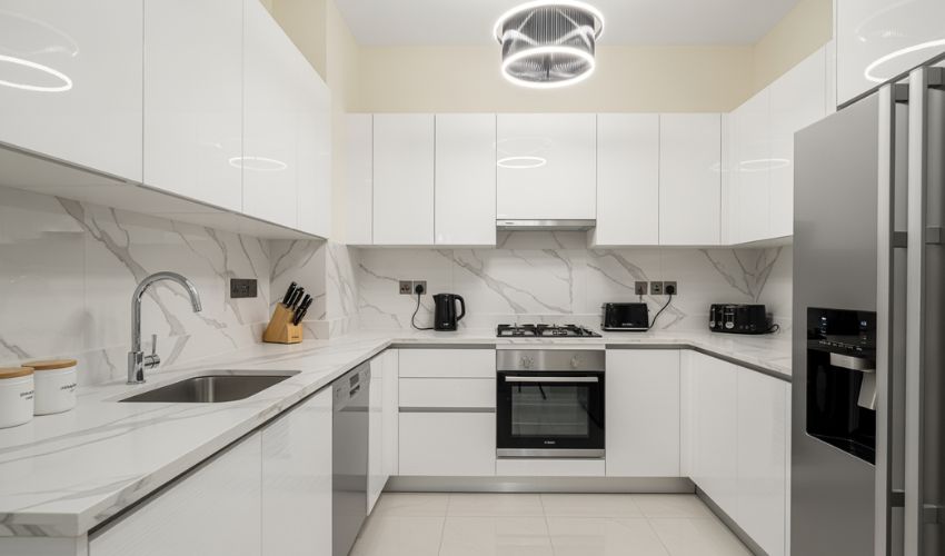 Modern renovated kitchen Dubai apartment property flip high-ROI upgrade wrapped cabinets luxury finishes.